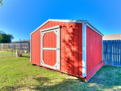 View of outbuilding featuring a lawn