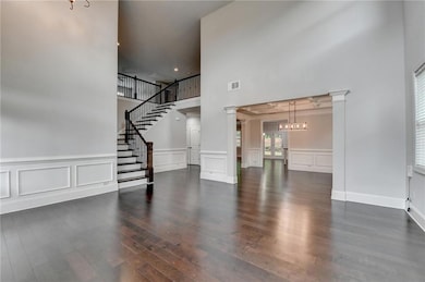 Unfurnished living room with a high ceiling, a dec