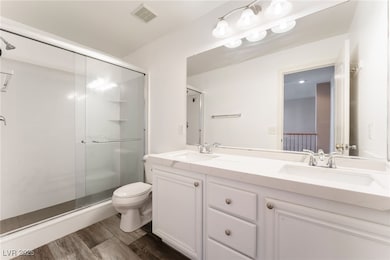 Full bath featuring a shower stall, wood finished
