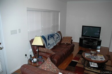 family room with hardwood floor, crown moulding an