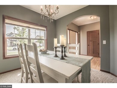 Formal dining room offers arched entry and front y