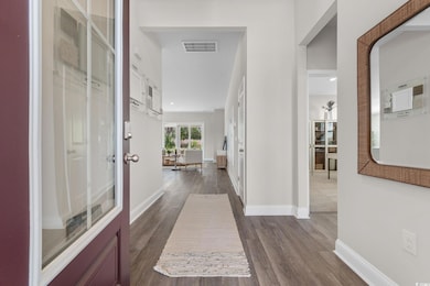 Corridor featuring dark wood-type flooring and baseboards