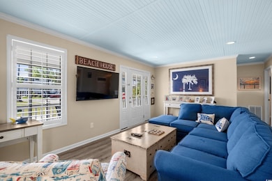 Living area with wood finished floors, visible ven