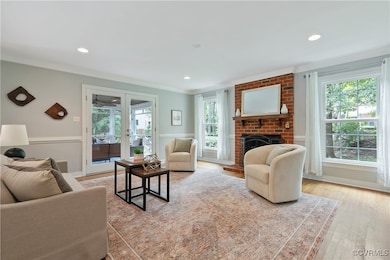 Living area with crown molding, a brick fireplace,