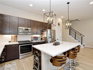 Kitchen with stainless steel appliances, light wo