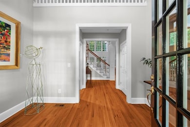 Corridor featuring wood finished floors and stairway