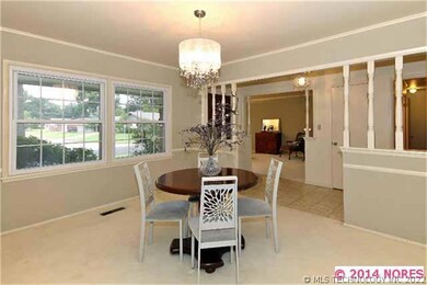 Enter the formal dining room through this half wal