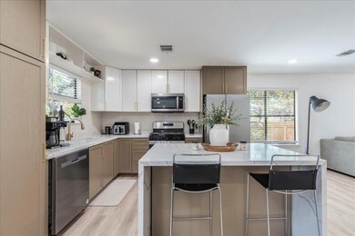 Kitchen with light wood finished floors, visible 