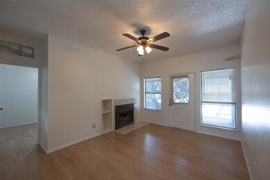 Unfurnished living room featuring a textured ceil