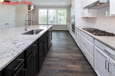 Spacious gourmet kitchen with double oven, gas coo