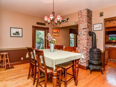 Dining Room with Hardwoods, Exposed Brick, Decorat