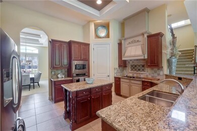 GOURMET KITCHEN HAS CUSTOM CABINETRY, ISLAND AS WE
