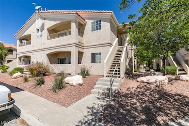 View of front facade featuring stucco siding, a ti