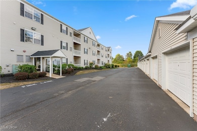 View of asphalt road with community garages