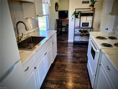 Kitchen featuring backsplash, light countertops, w