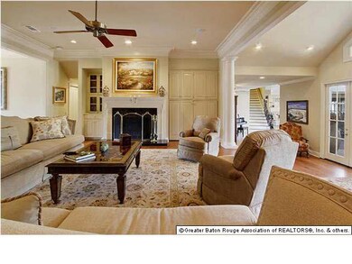FORMAL LIVING ROOM WITH VIEW OF STAIRS AND FIREPLA