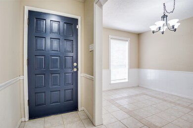 As you enter, the formal dining room with tons of natural lighting is to your left.