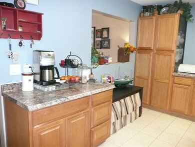 Kitchen has large opening to living room.