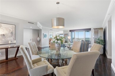 Dining room featuring crown molding and dark wood-style flooring