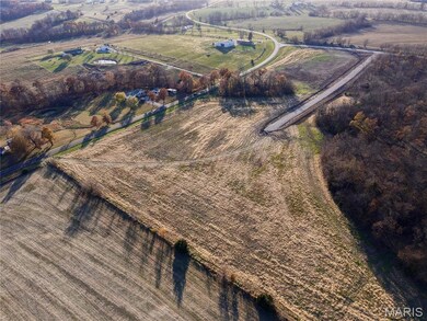 Aerial view of property and surrounding area featuring rural landscape