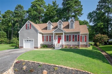 New england style home featuring a garage and a fr