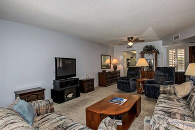 Living area looking to kitchen