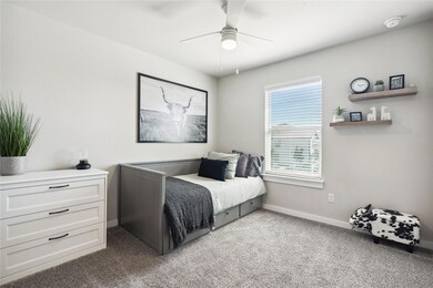Bedroom with carpet, baseboards, and ceiling fan