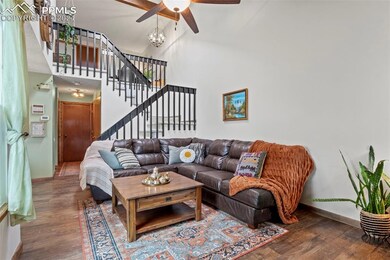 Living room with ceiling fan, dark hardwood / wood