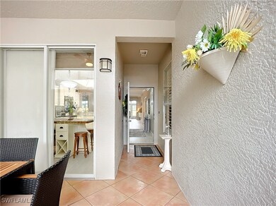 Hall with a textured ceiling and light tile patter