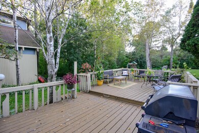 Wooden terrace featuring area for grilling