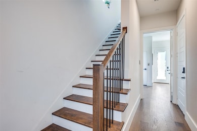 Stairs featuring hardwood / wood-style floors