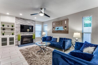 Living room featuring built in features, ceiling f