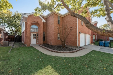 Traditional-style home with concrete driveway, brick siding, and a garage