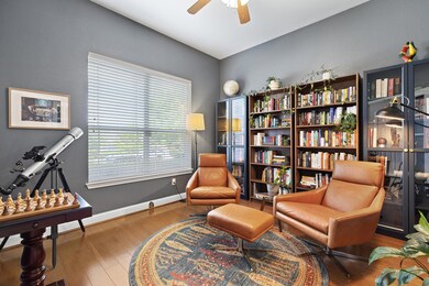 Sitting room featuring a ceiling fan, baseboards,