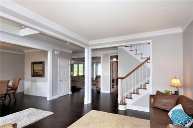 Double height entry, dark hardwoods and extra wide