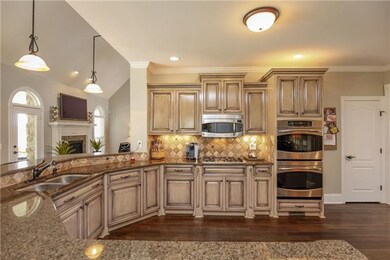 The kitchen features 23 custom glazed cabinets, an