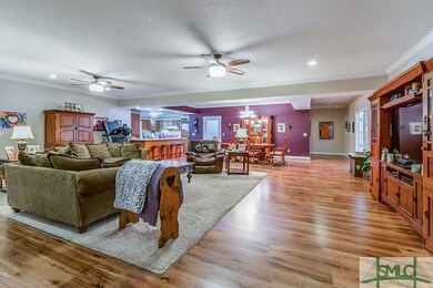 Large living area with kitchen on the left and sun