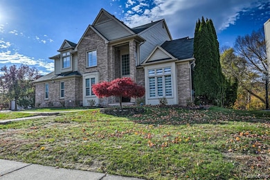 View of front of home featuring a front lawn and brick siding