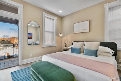 Bedroom featuring wood finished floors, access to outside, and recessed lighting
