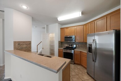 Kitchen with stainless steel appliances, light ti