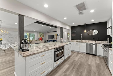 Kitchen featuring stainless steel appliances, a si