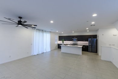 Kitchen featuring refrigerator with ice dispenser,