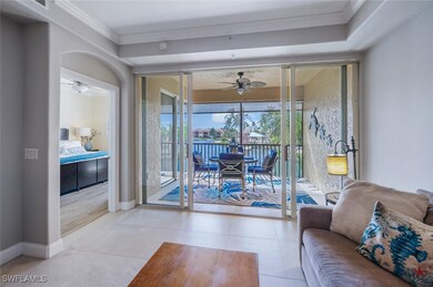 Tiled living room featuring ceiling fan, a water view, a sunroom, and crown molding