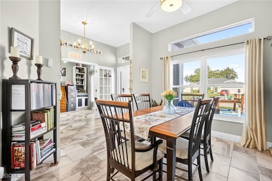 Dining room featuring a chandelier, a high ceiling