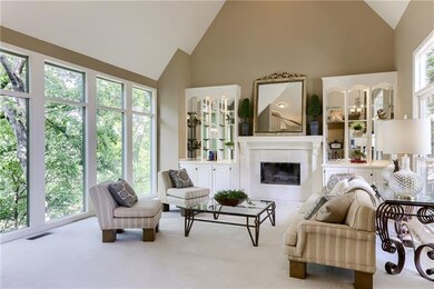 Living room with soaring ceilings, fireplace and b