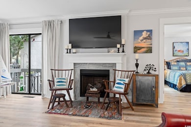 Interior space with a fireplace, crown molding, an