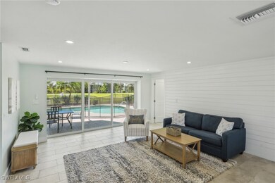 Living area with recessed lighting and wooden wall