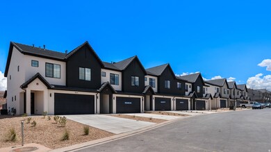 View of front of property featuring stucco siding, concrete driveway, a residential view, and a garage