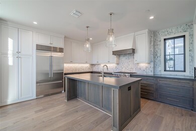 Kitchen with sink, an island with sink, pendant li