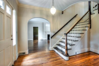 Grand foyer with archways leading to living room